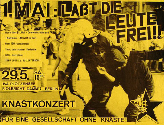 Gelbes Plakat mit fetter schwarzer Schrift: "1. Mai: Laßt die Leute frei!!" und "Knastkonzert". Bild eines Polizeibeamten, der eine Person festhält. Enthält Angaben zur Veranstaltung: "29.5. JVA Plötzensee Berlin".
