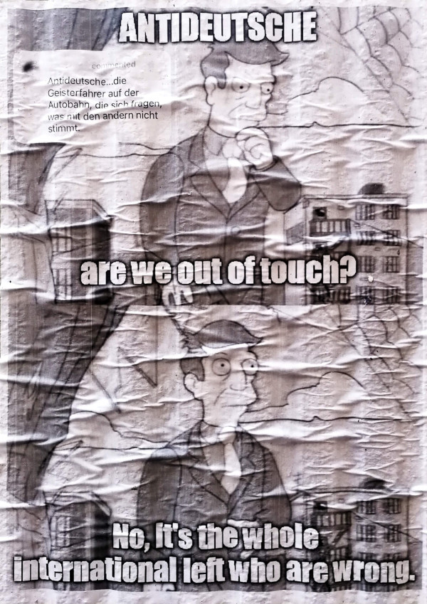 Ein zerknittertes Plakat zeigt einen denkenden Cartoon-Mann mit dem Text: "Antideutsche: Sind wir nicht mehr auf dem Laufenden? Nein, es ist die gesamte internationale Linke, die falsch liegt".